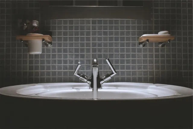 Bathroom with tiled wall and washbasin