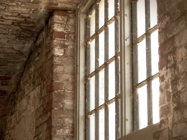 Exposed brick wall next to tall windows