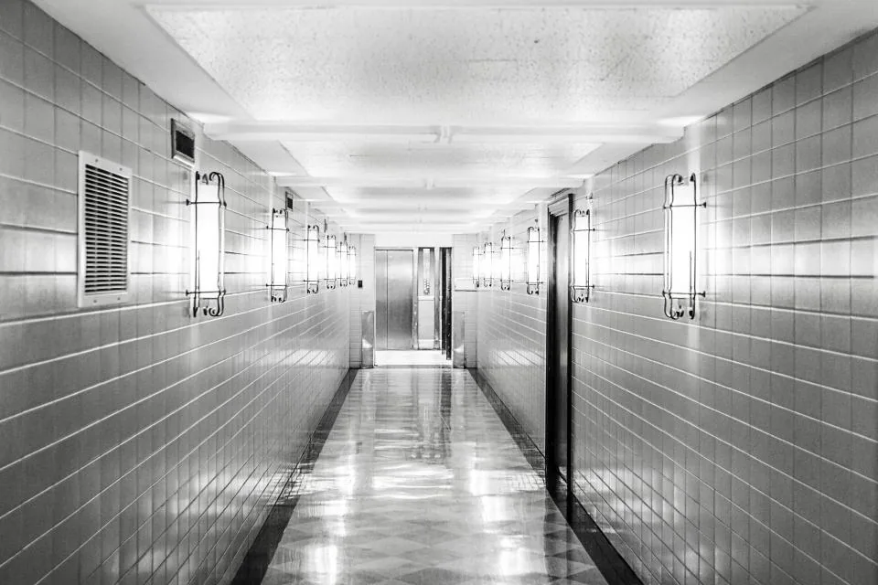 Long corridor with tiled walls and floor
